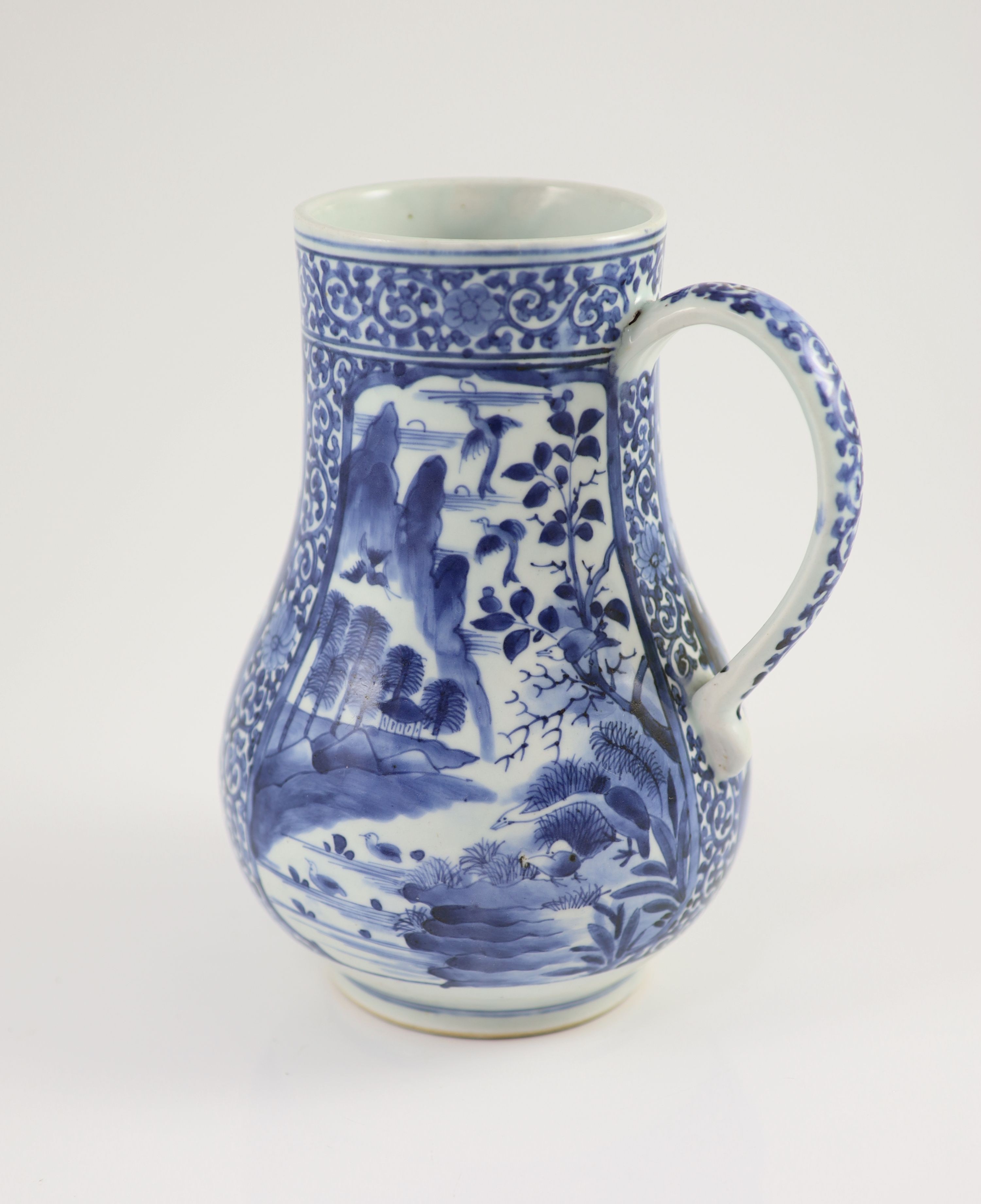 A Japanese Arita blue and white tankard, c.1700, 23.8 cm high